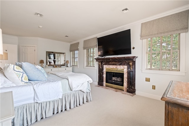 bedroom with carpet, crown molding, a premium fireplace, and multiple windows