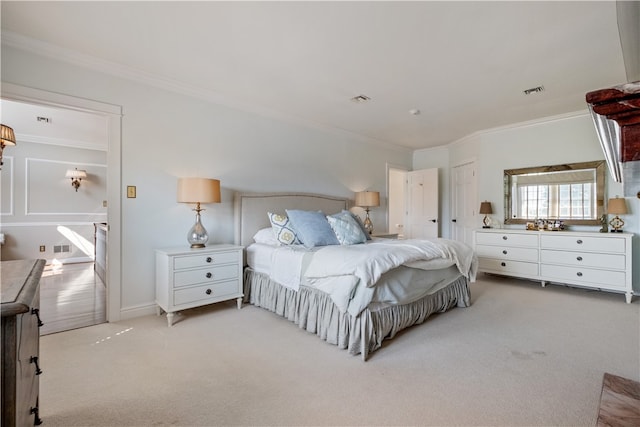 bedroom featuring crown molding and light carpet