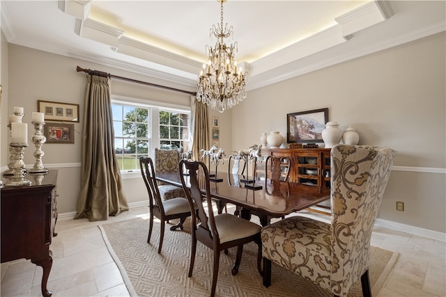 tiled dining room featuring crown molding, a notable chandelier, and a tray ceiling