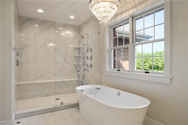 bathroom featuring a notable chandelier and shower with separate bathtub