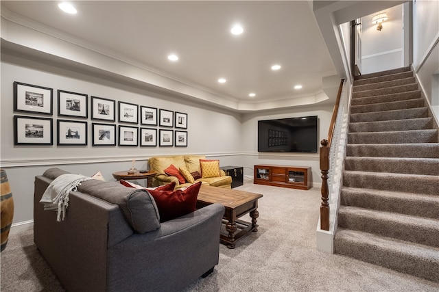 carpeted living room with crown molding and a tray ceiling