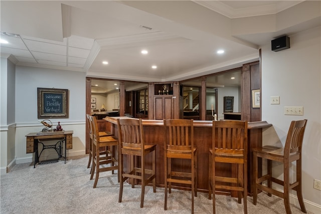 bar with ornamental molding and light colored carpet