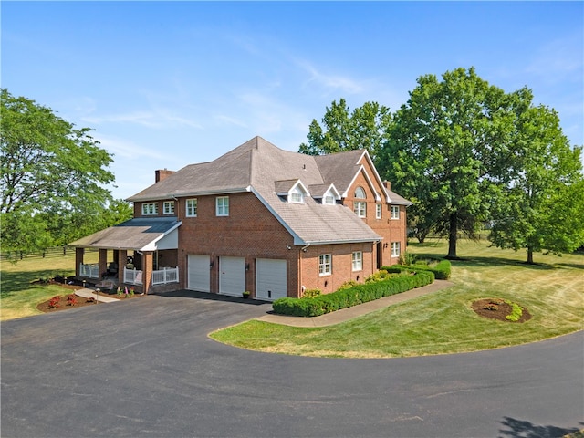 view of front of house with a garage and a front lawn