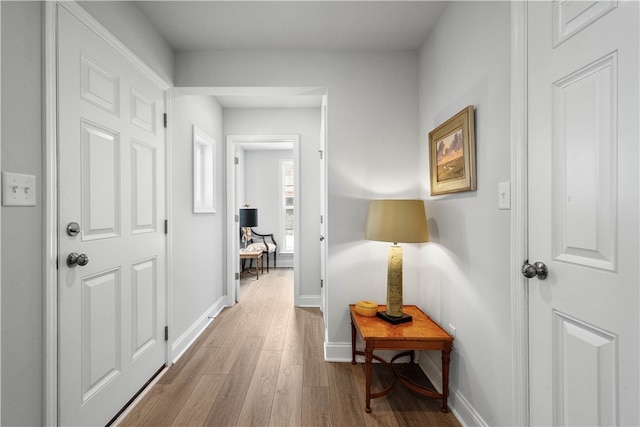 corridor with light wood-type flooring