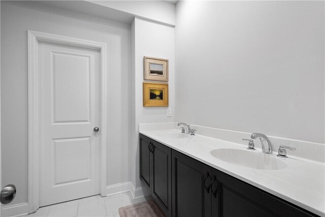 bathroom with dual vanity and tile patterned floors