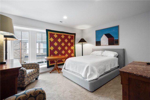 carpeted bedroom with multiple windows