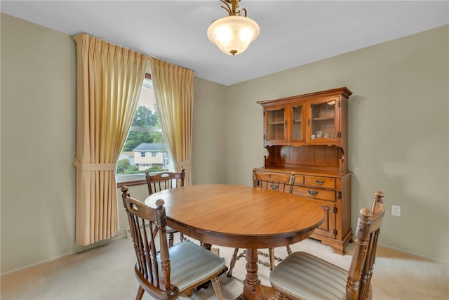 dining area featuring light carpet