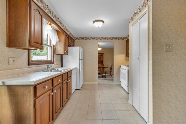 kitchen featuring light tile patterned flooring, sink, and gas range gas stove