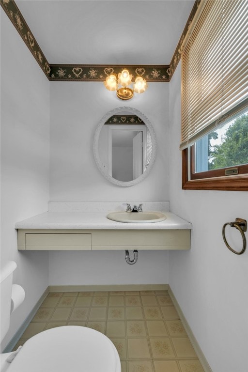 bathroom featuring sink, toilet, and tile patterned floors