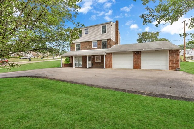 view of front facade with a garage and a front lawn