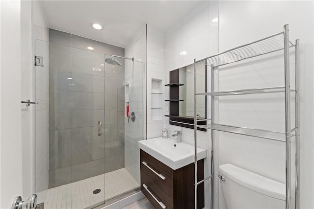 bathroom with vanity, a shower stall, toilet, and recessed lighting