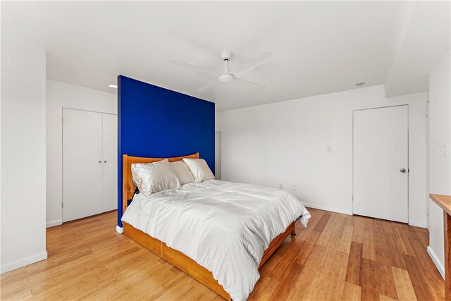 bedroom with ceiling fan and light hardwood / wood-style flooring