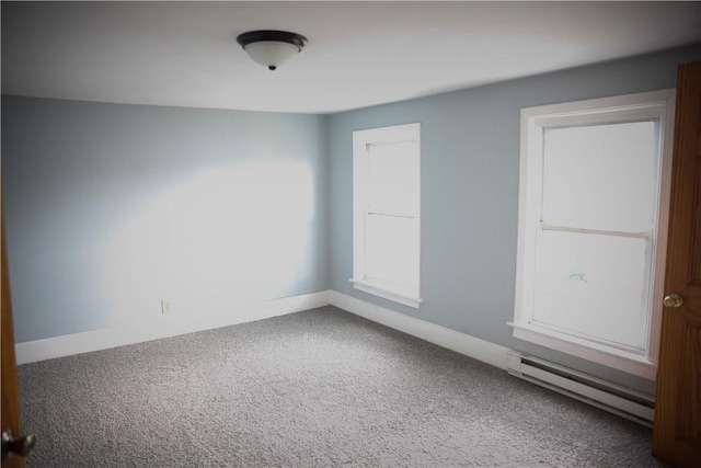 carpeted spare room featuring baseboard heating