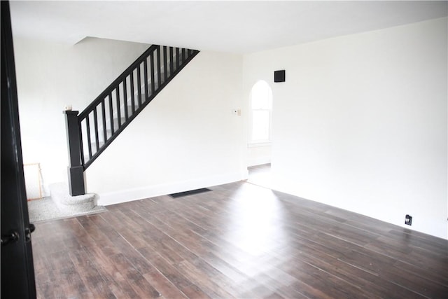 unfurnished living room with dark hardwood / wood-style flooring