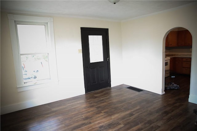 entrance foyer with dark wood-type flooring and ornamental molding