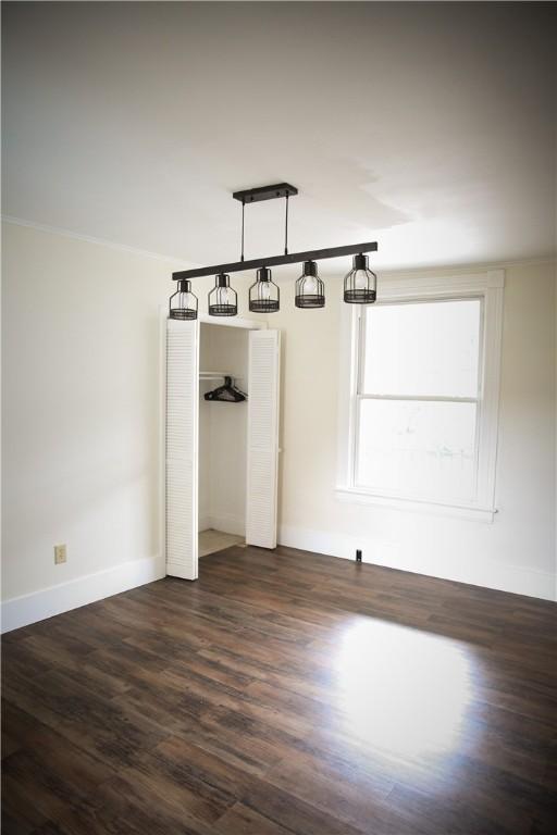 spare room with dark hardwood / wood-style flooring