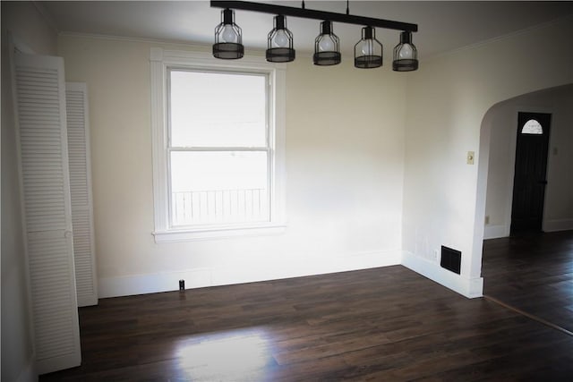 unfurnished dining area with crown molding, dark wood-type flooring, and a wealth of natural light