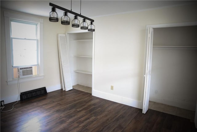 interior space featuring multiple windows, cooling unit, dark wood-type flooring, and ornamental molding