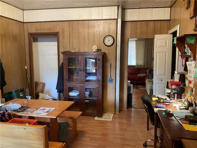 office with wood walls and light wood finished floors