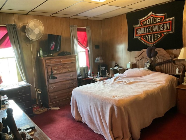 bedroom featuring carpet floors and wooden walls