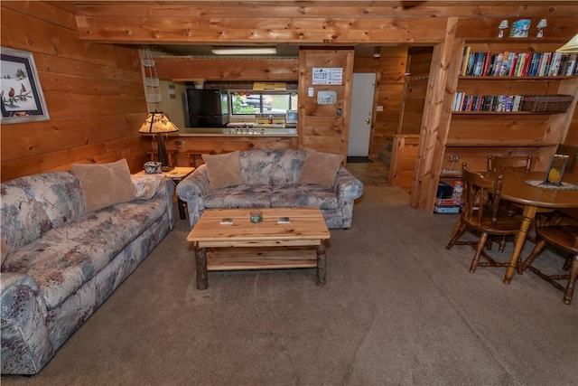 living room with wood walls and carpet floors