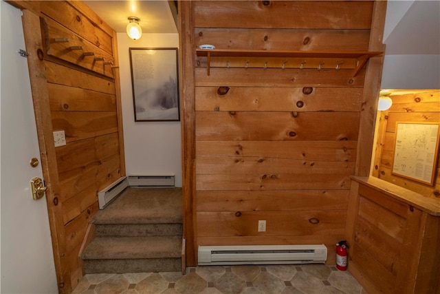 entryway featuring wood walls and a baseboard radiator