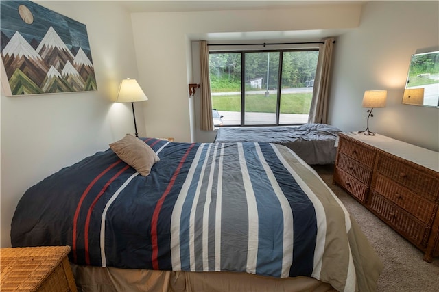 bedroom with access to exterior and carpet floors