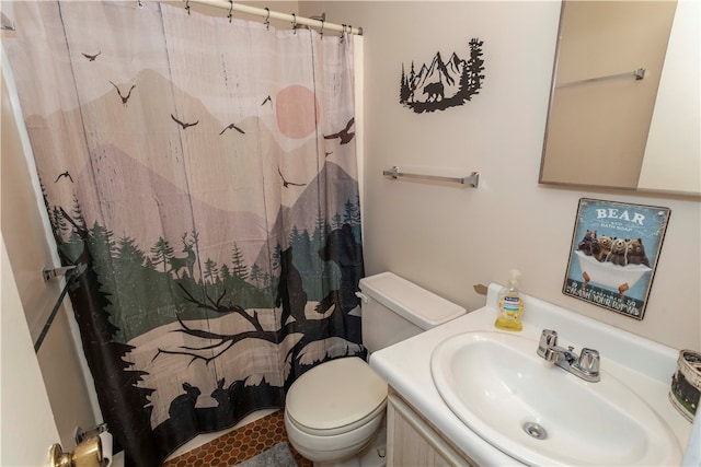 bathroom featuring tile patterned flooring, vanity, toilet, and walk in shower