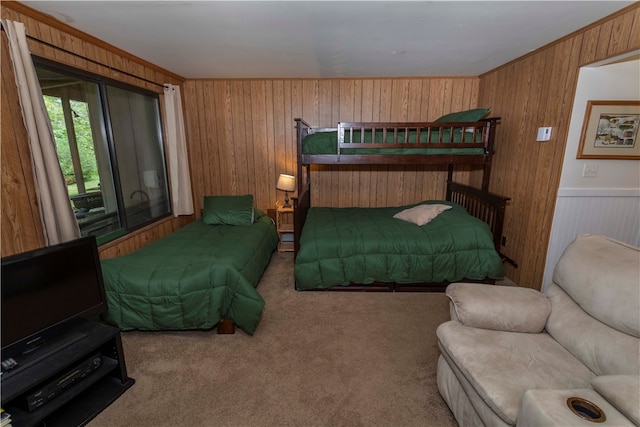 bedroom featuring wooden walls, crown molding, and light colored carpet