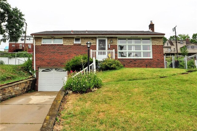 view of front facade with a garage and a front lawn