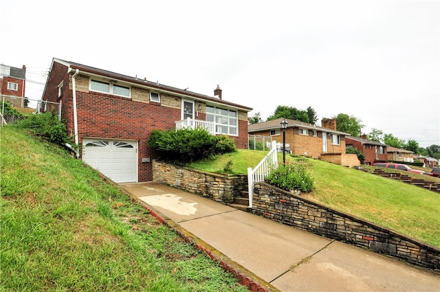 view of front facade with a garage and a front lawn