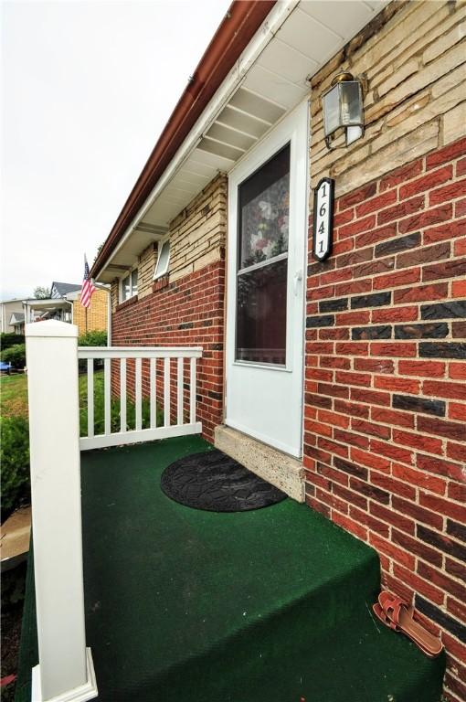 view of exterior entry with covered porch