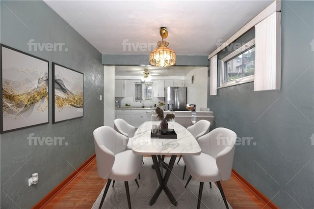 dining area with ceiling fan and sink