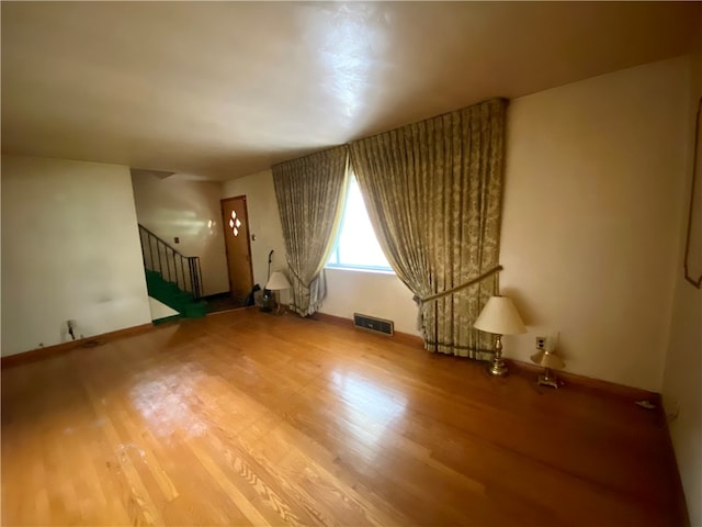 empty room featuring wood-type flooring