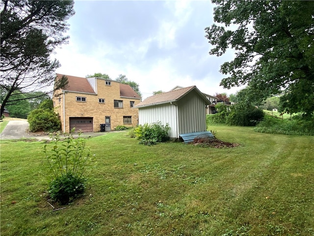 back of house with a garage and a yard