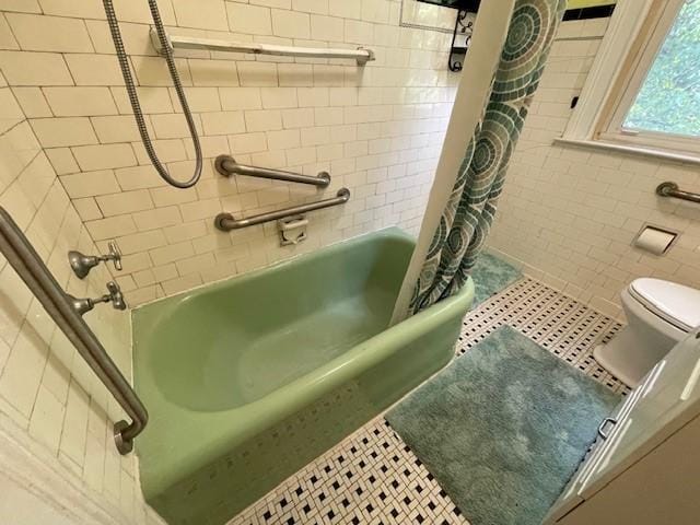 bathroom featuring shower / tub combo with curtain, tile patterned flooring, and toilet