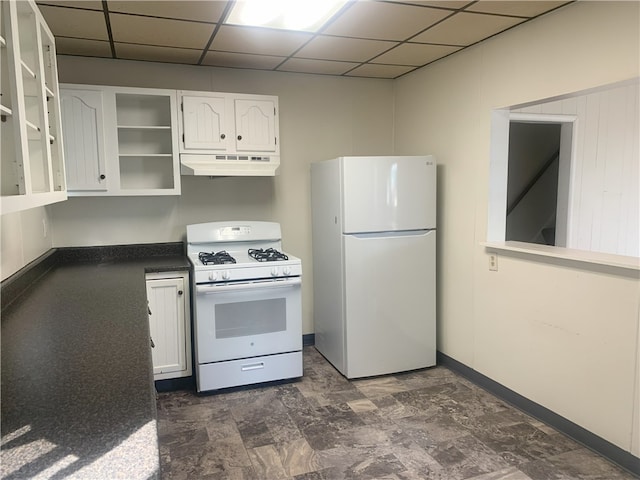 kitchen with a drop ceiling, white appliances, and white cabinetry