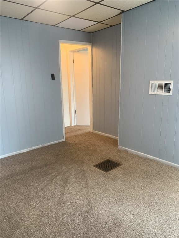 unfurnished room featuring carpet floors and a paneled ceiling