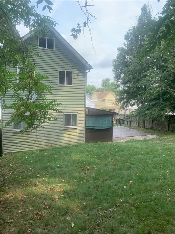 view of side of property with a patio and a yard