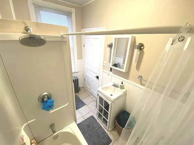 bathroom with sink, radiator heating unit, shower / tub combo, and tile patterned flooring