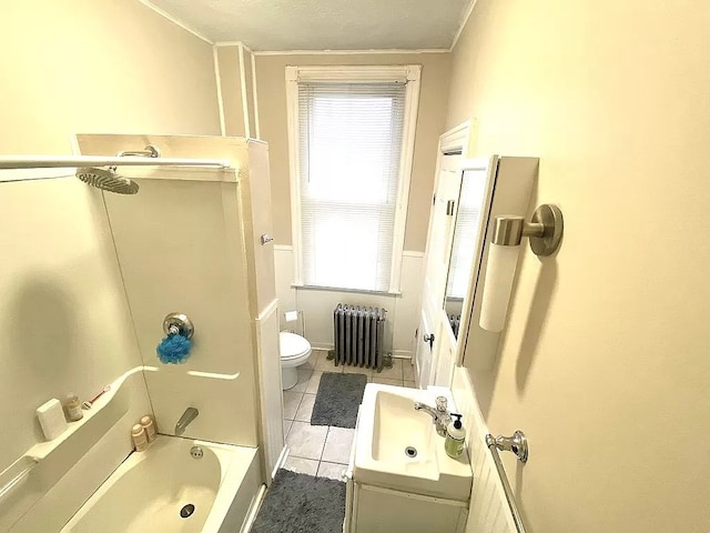 full bathroom with radiator heating unit, washtub / shower combination, tile patterned flooring, toilet, and vanity