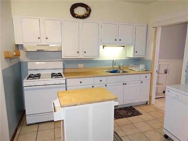 kitchen with white cabinetry, white appliances, and light tile patterned floors