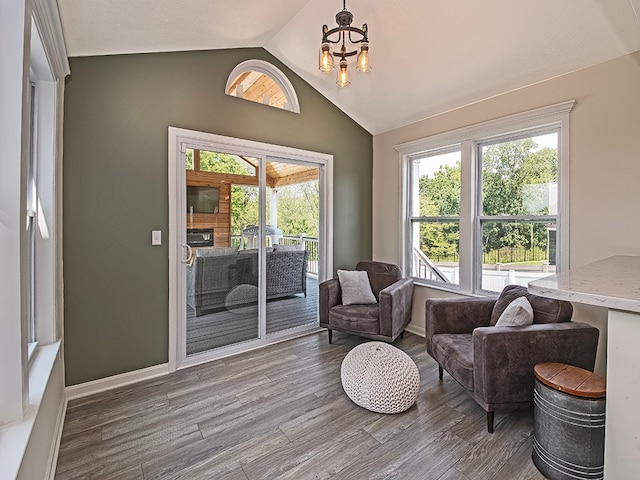 sunroom with a chandelier and lofted ceiling