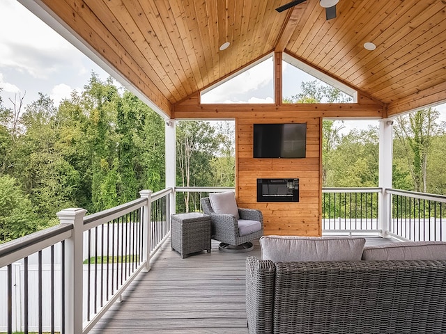 wooden terrace with an outdoor living space