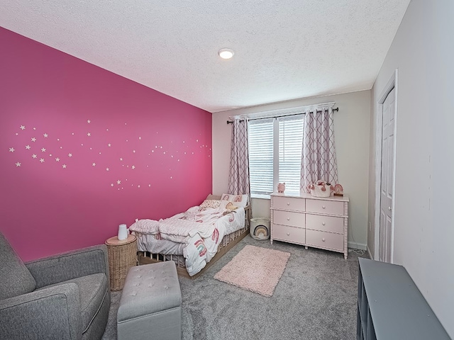 carpeted bedroom with a closet and a textured ceiling