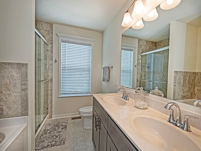 full bathroom with tile patterned flooring, independent shower and bath, dual vanity, and plenty of natural light