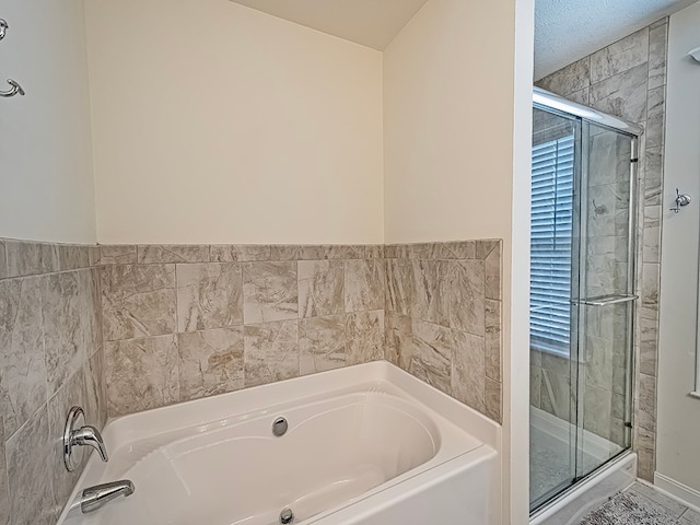 bathroom featuring separate shower and tub and tile patterned flooring