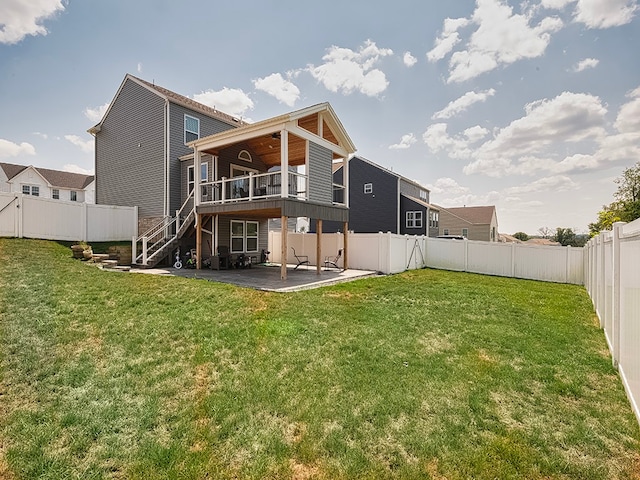 rear view of house featuring a patio and a lawn