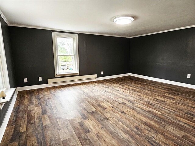 unfurnished room with crown molding, a baseboard heating unit, and hardwood / wood-style floors