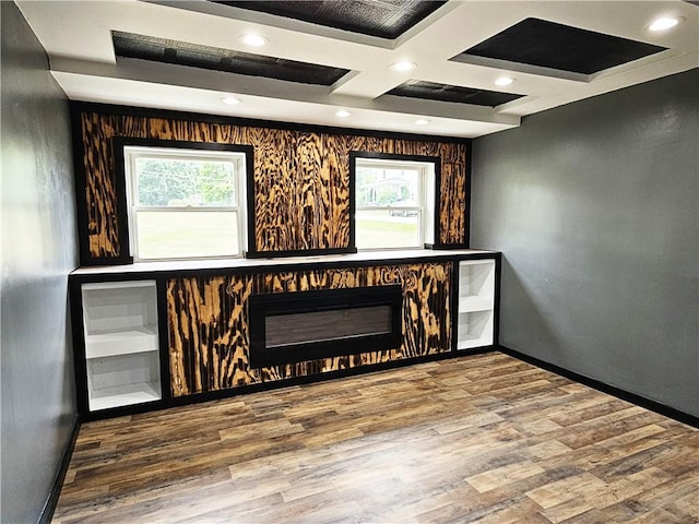 interior space with plenty of natural light, baseboards, and wood finished floors